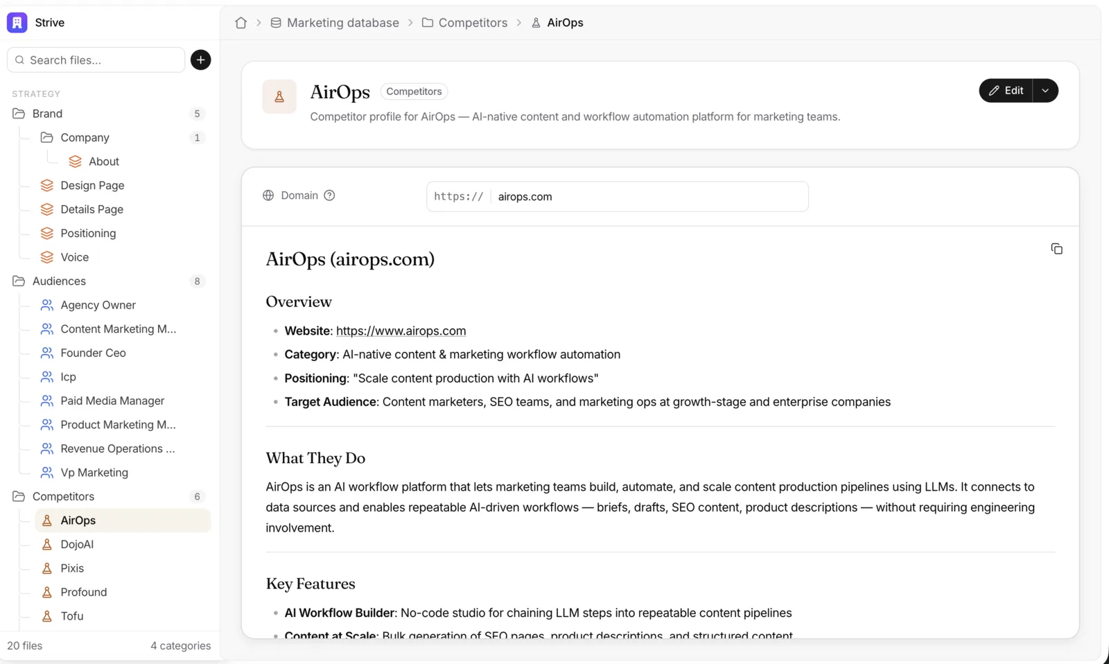 The live competitor file for AirOps in Strive: the files sidebar with Brand, Audiences and Competitors folders, a header card with the file’s icon, title, a Competitors chip and a one-line description, and an Edit button. Below, one property row, Domain, with a help icon and a field reading https:// airops.com, then the doc itself, rendered: an Overview list and a section on what they do.