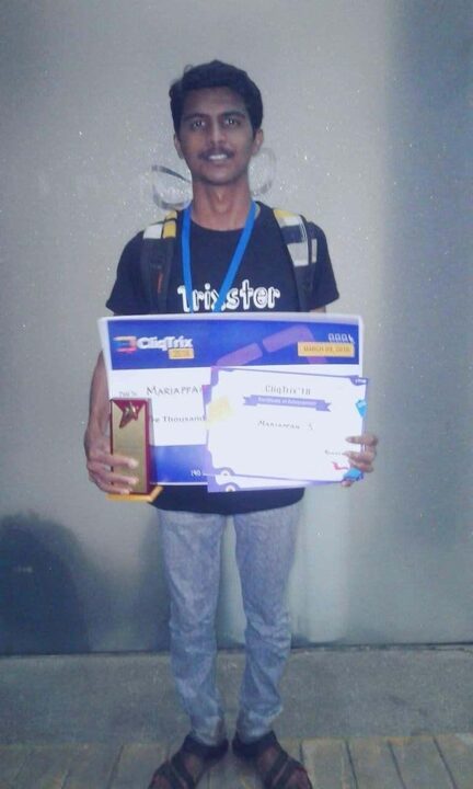 Mariappan holding a Cliqtrix '18 certificate, prize cheque and trophy